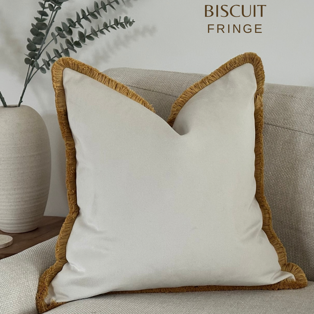 The best luxury ivory pillows with mustard fringe.
