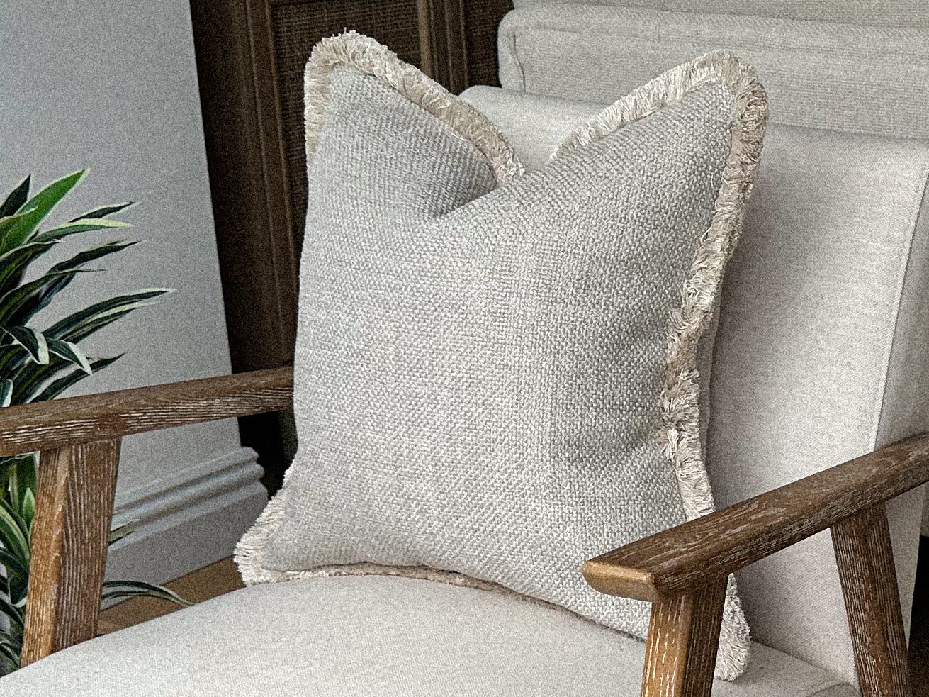 Luxury neutral fringed cushions.