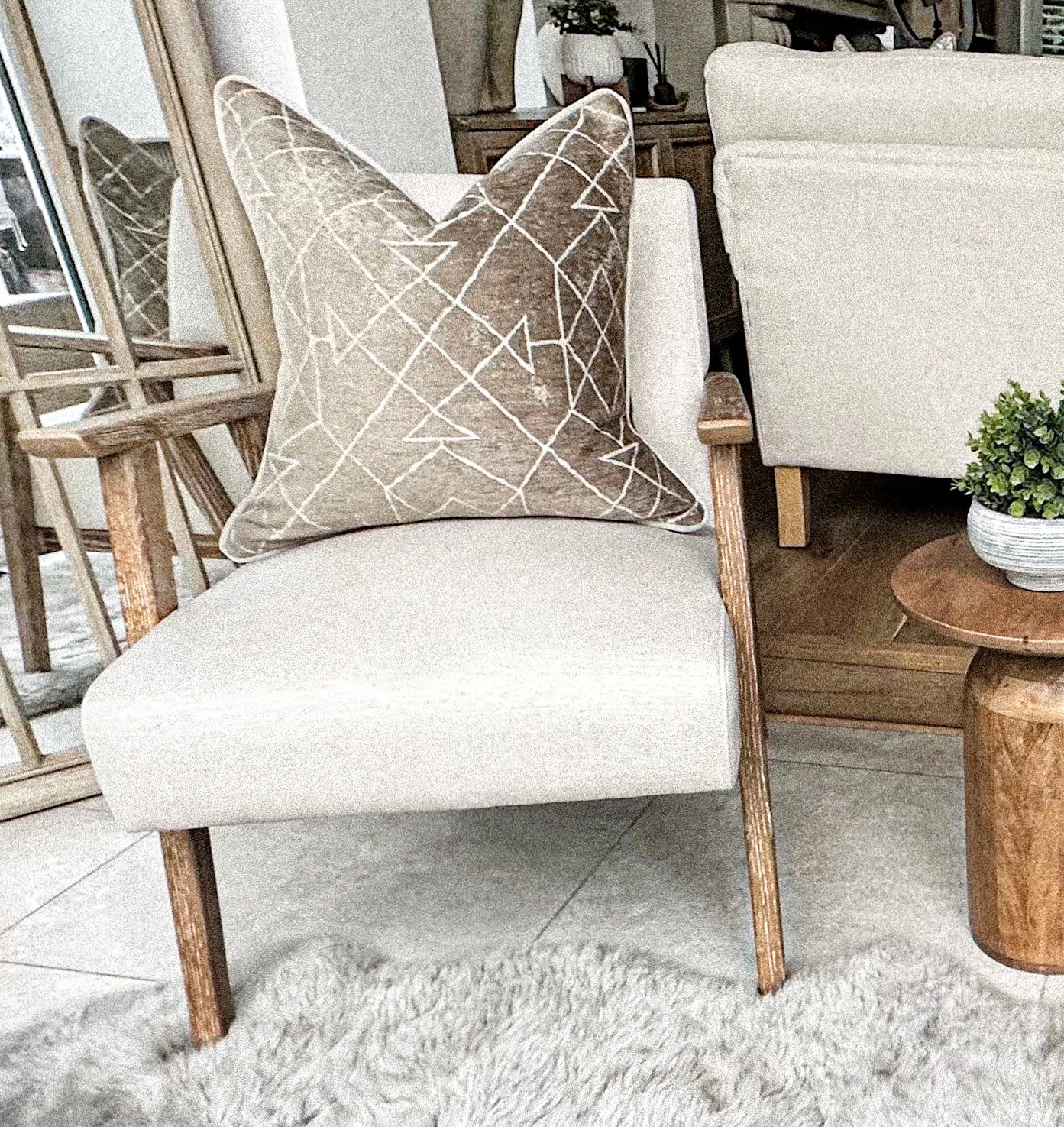 Beige scatter cushion with white lines Aztec style.