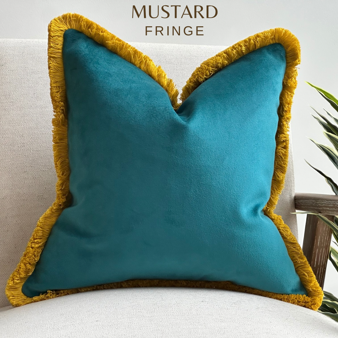 Teal velvet pillow with mustards fringing.