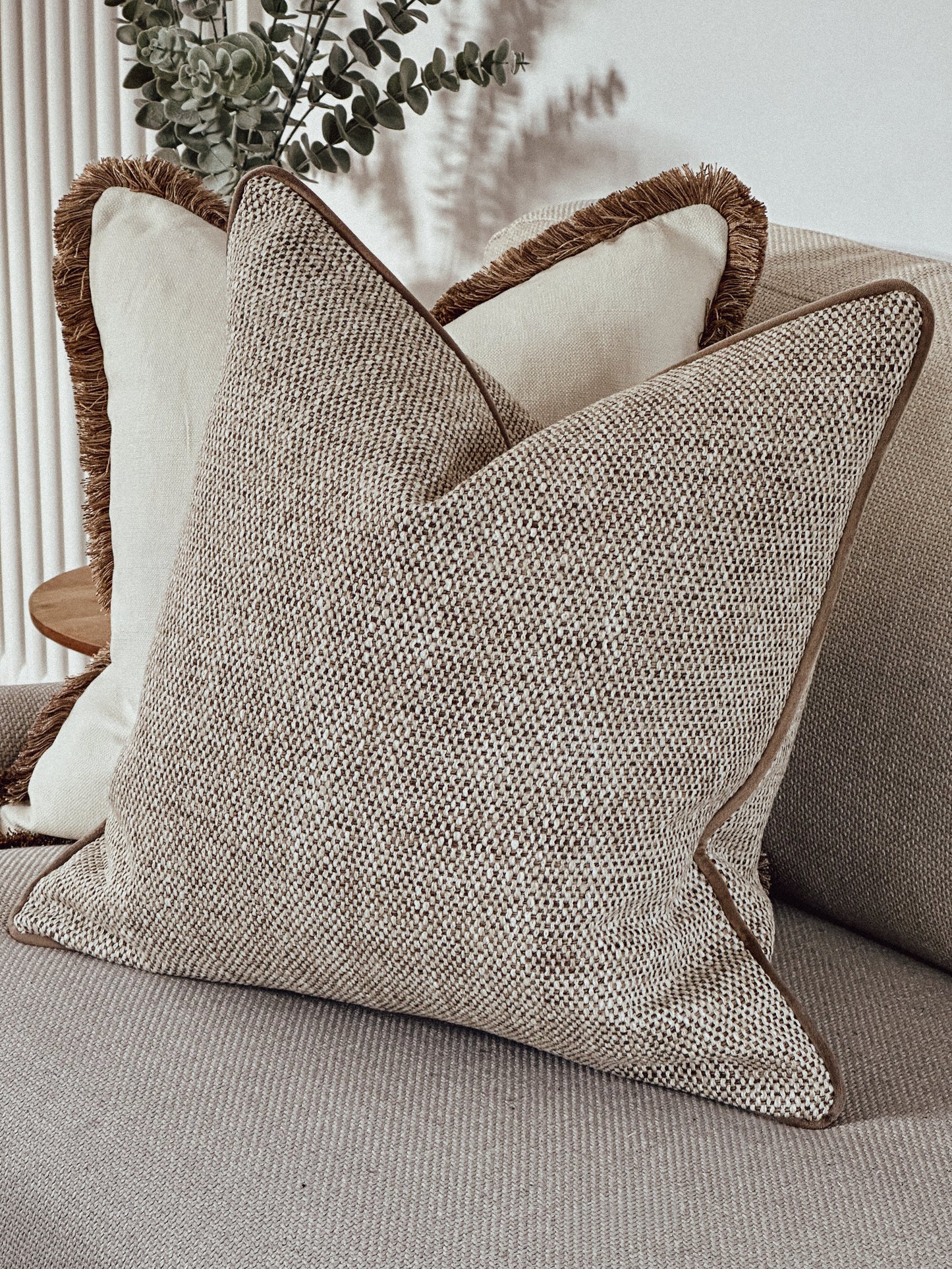 Scatter cushion in a beige and ivory textured weave.