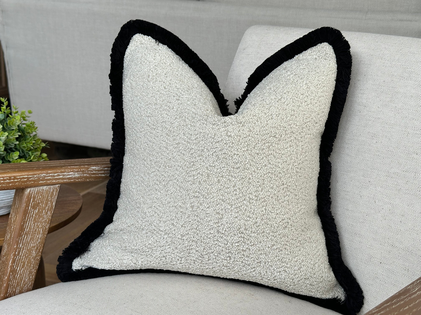 Cream beige boucle with black contrast fringe.