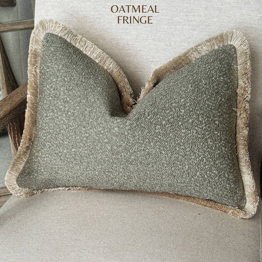 Sage green boucle fringed cushion.