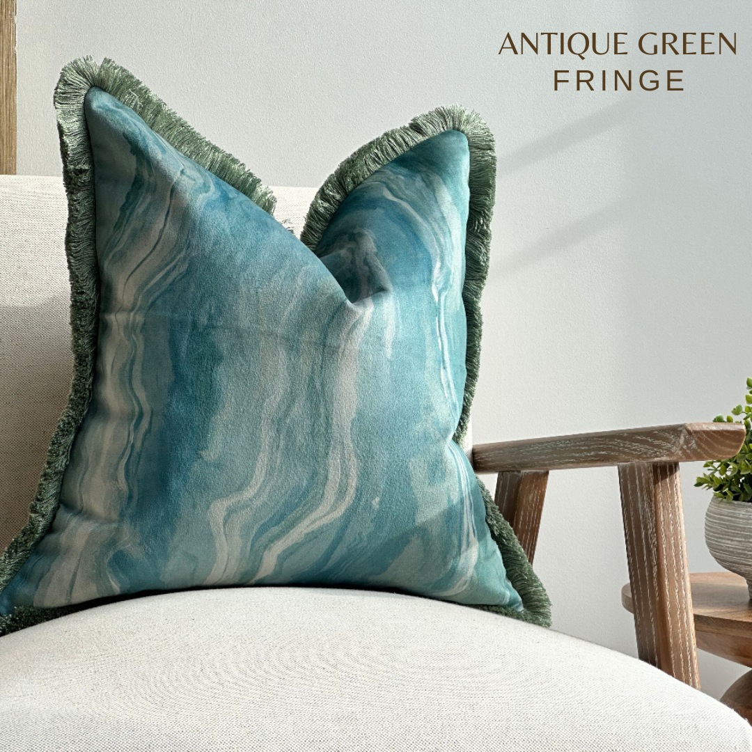 Blue and green pattern velvet cushion with fringe trim