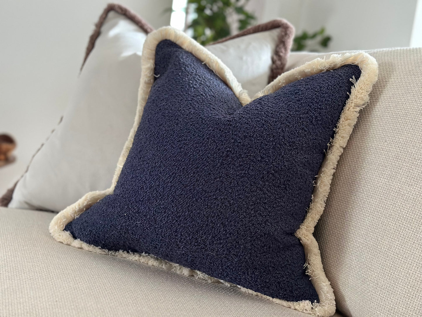 Blue boucle cushion with fringe or piping