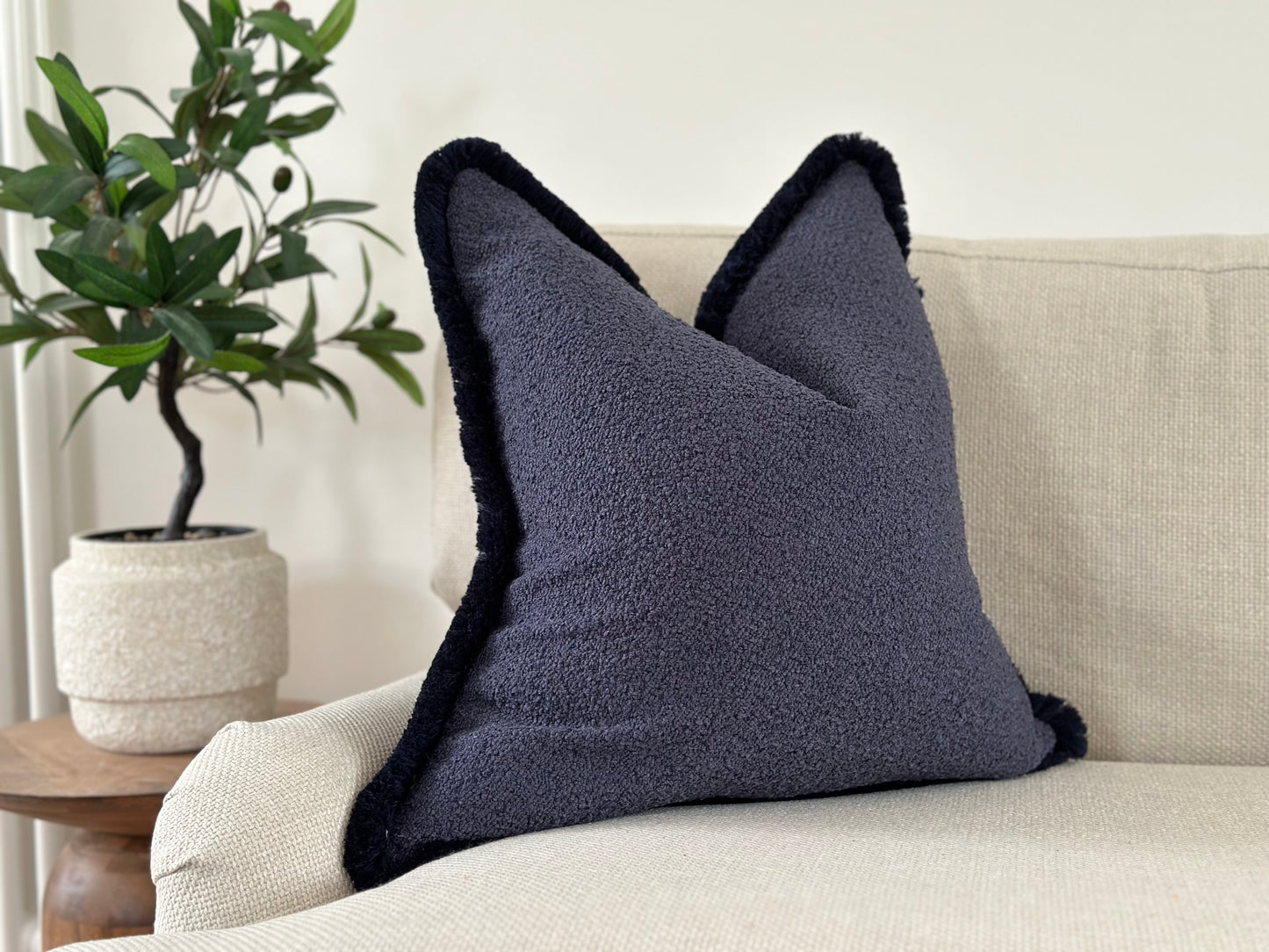 Blue boucle fringe cushion