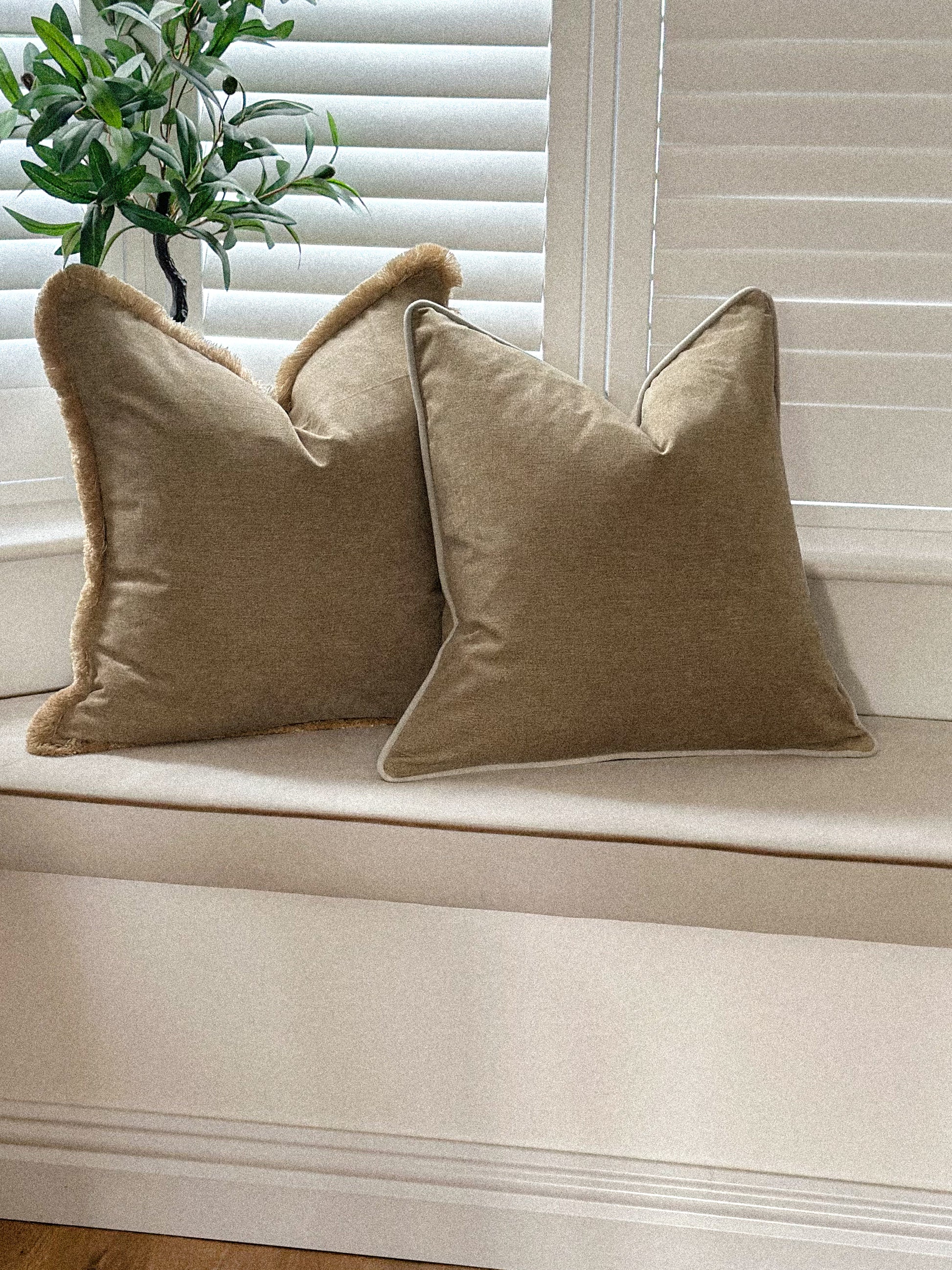 Cosy golden brown pillow cover adding warmth to a living room corner.