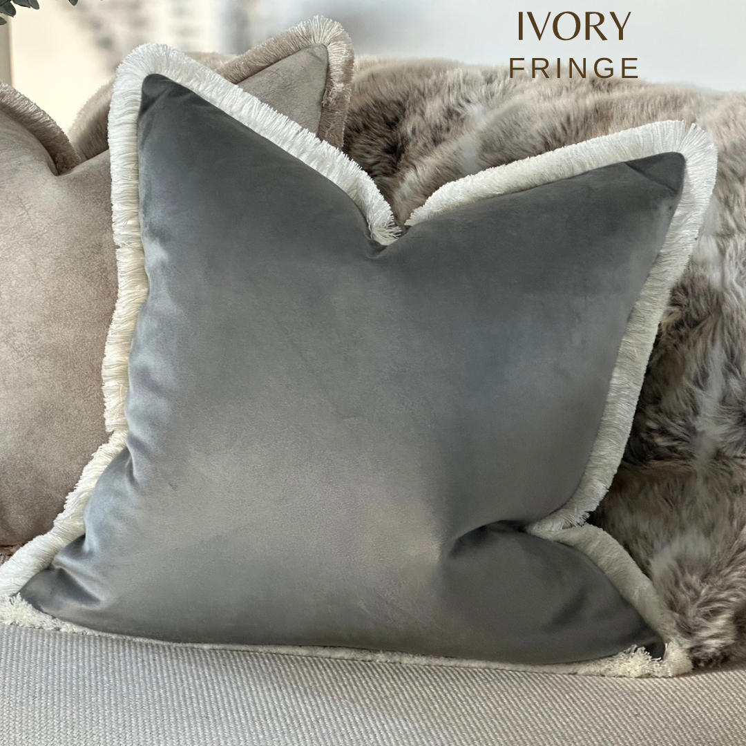 Grey velvet cushion with white ivory fringe trim