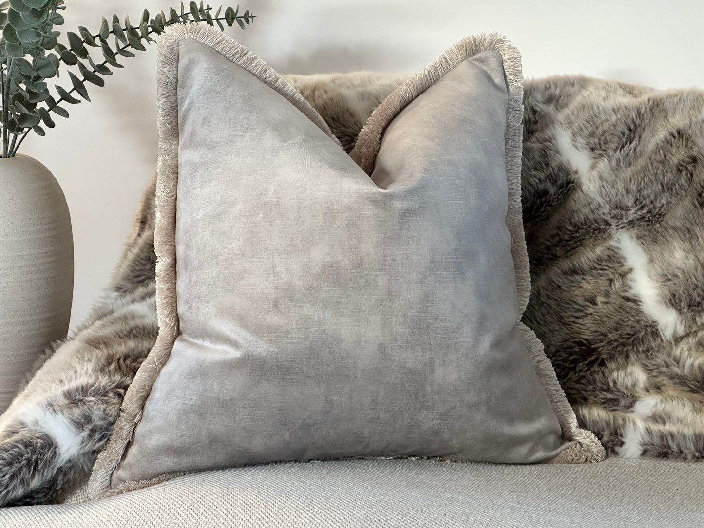Beautiful luxury velvet grey cushion with fringed edge.