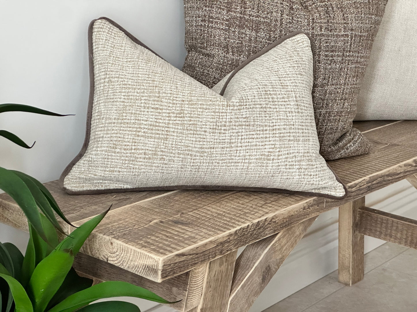 Modern organic cushion with a textured look in cream.