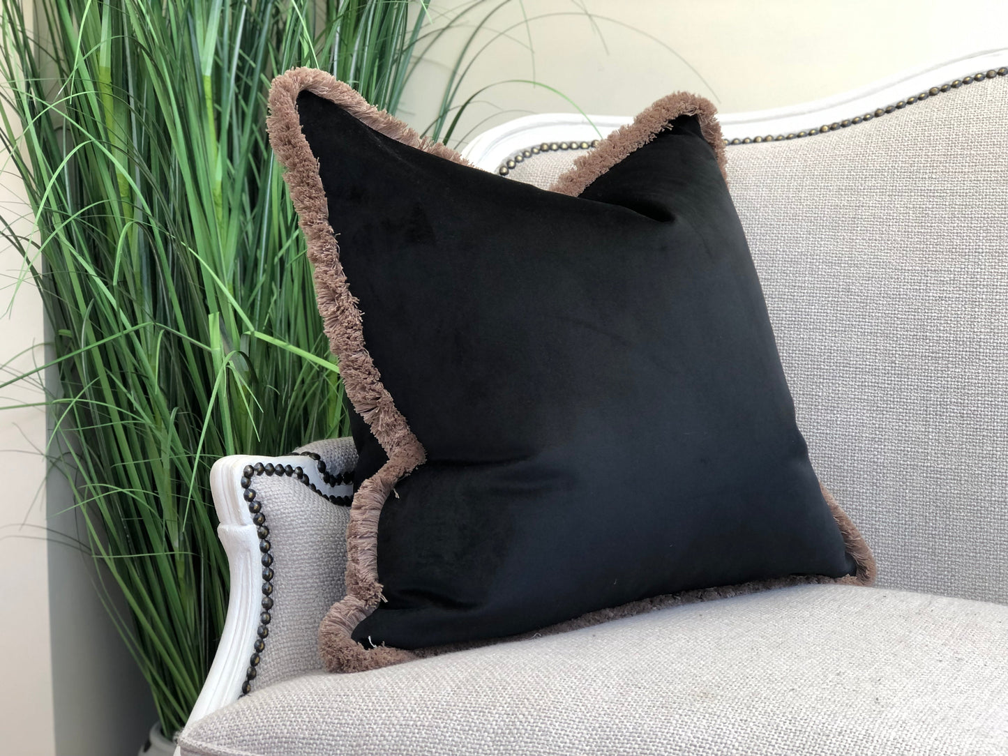 Black velvet fringed cushion