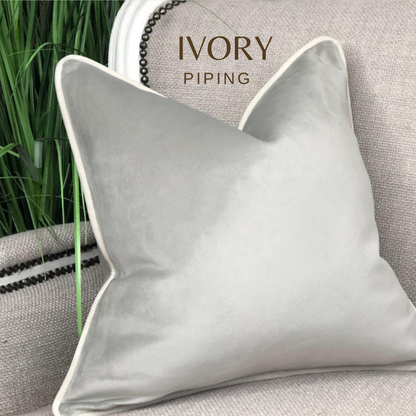 Silver velvet cushion cover with ivory piping.