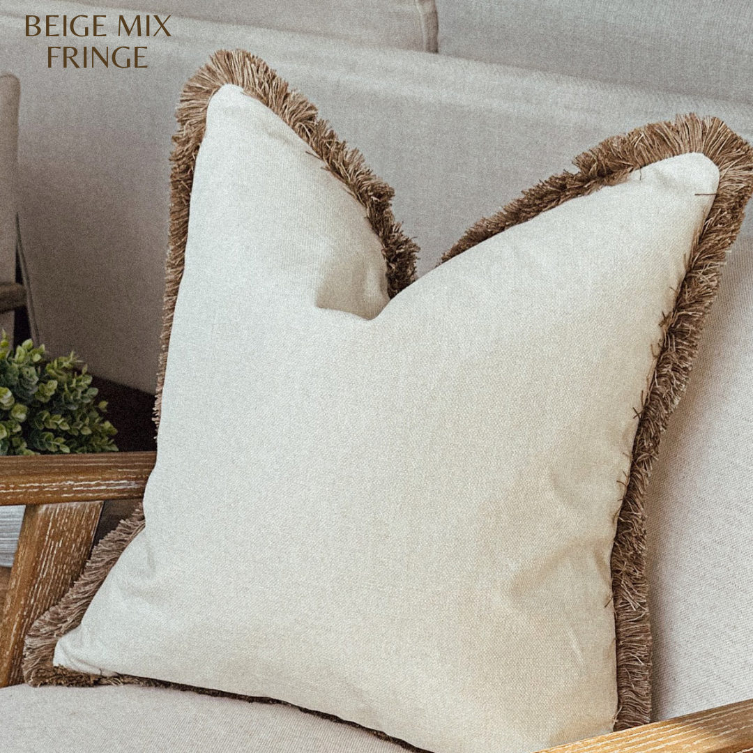 Neutral cream scatter cushion with fringing.