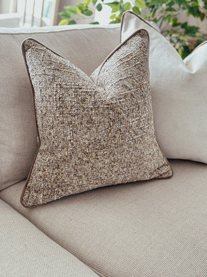 Chunky textured scatter cushion in warm caramel hues — perfect for creating a layered, inviting look.
