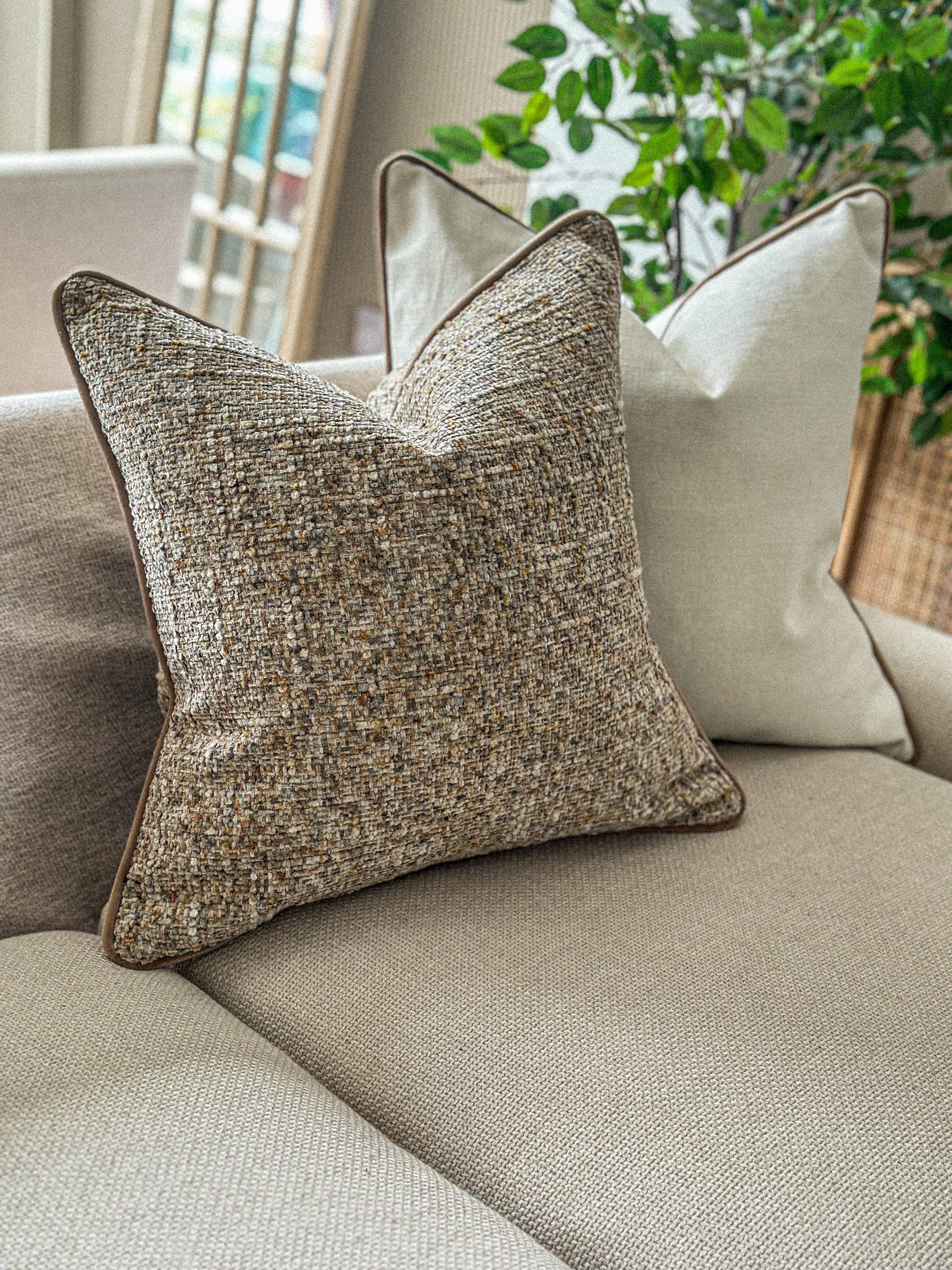 Earthy woven pillow cover in golden brown tones — ideal for neutral and rustic interiors.
