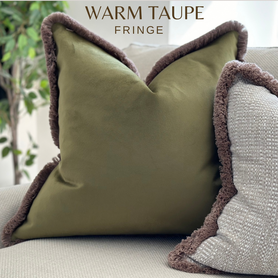 Olive green velvet pillow with beige fringed trim 