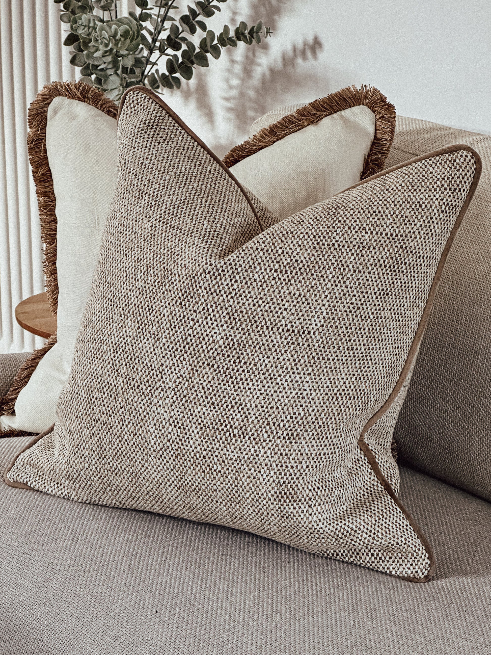 Scatter cushion in a beige and ivory textured weave.