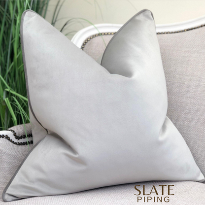 Silver grey velvet cushion cover with dark grey piping.