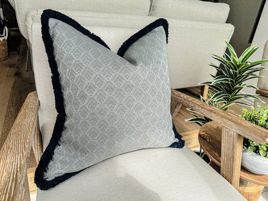 Silver grey Geometric cushion cover with fringe trim.