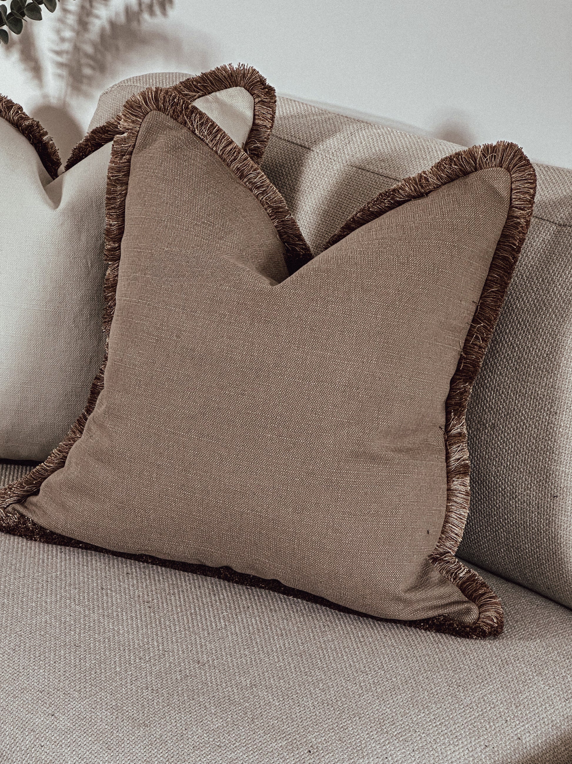 Luxury Warm earthy neutral scatter cushions with fluffy edge.