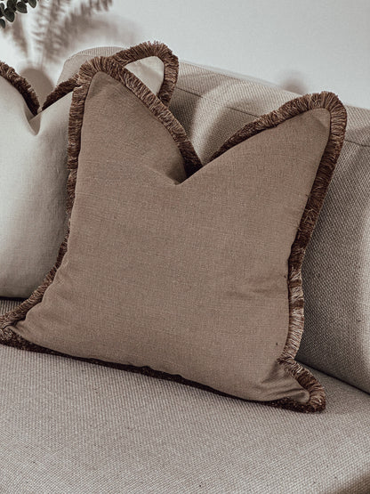Luxury Warm earthy neutral scatter cushions with fluffy edge.