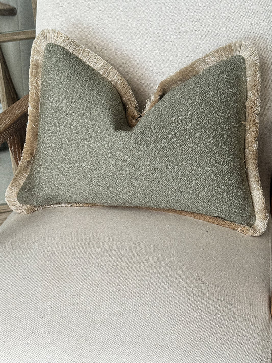 Sage green boucle fringed cushion.