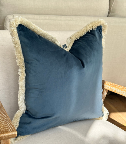 Navy blue velvet fringed throw pillow.
