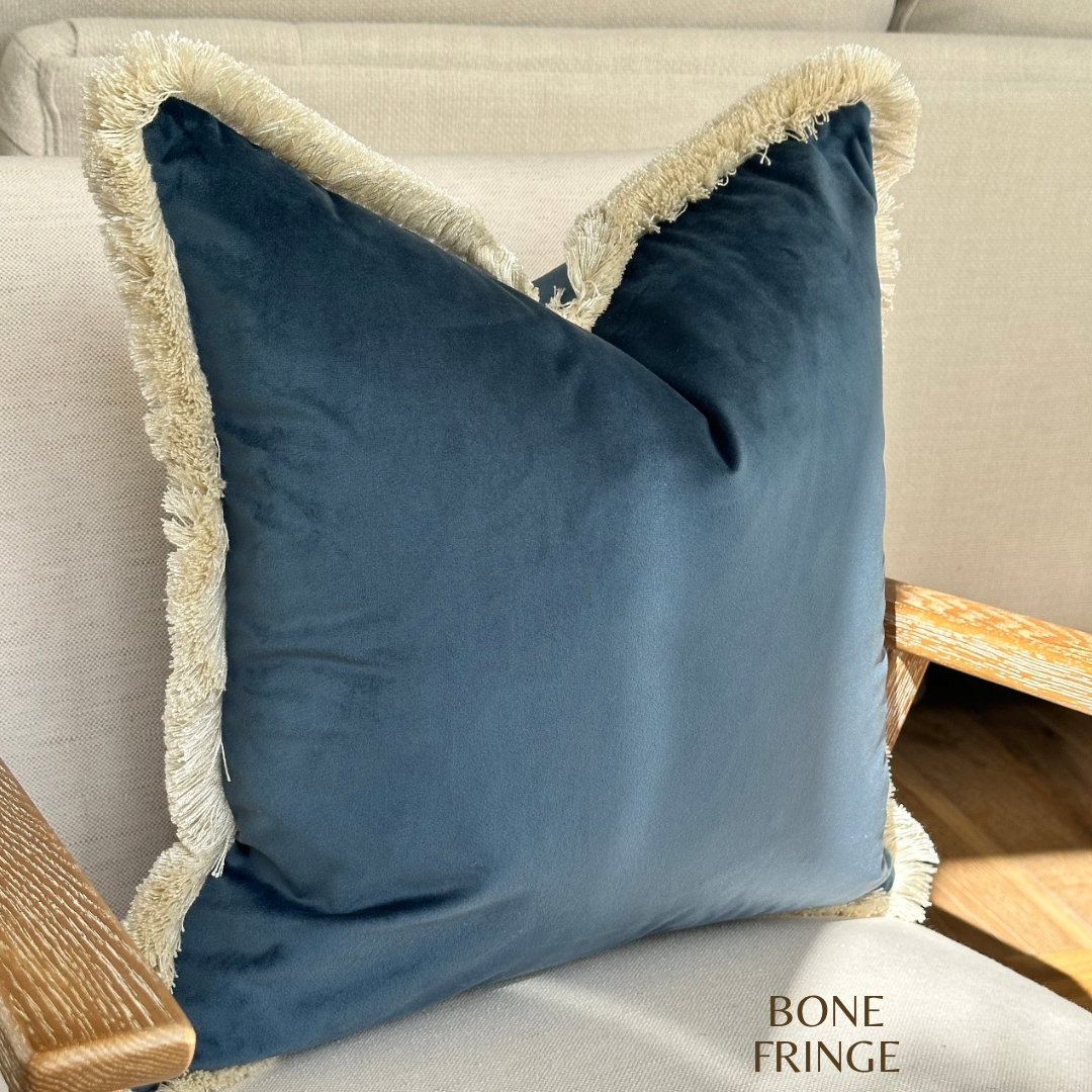 Blue navy throw pillow with fringing.