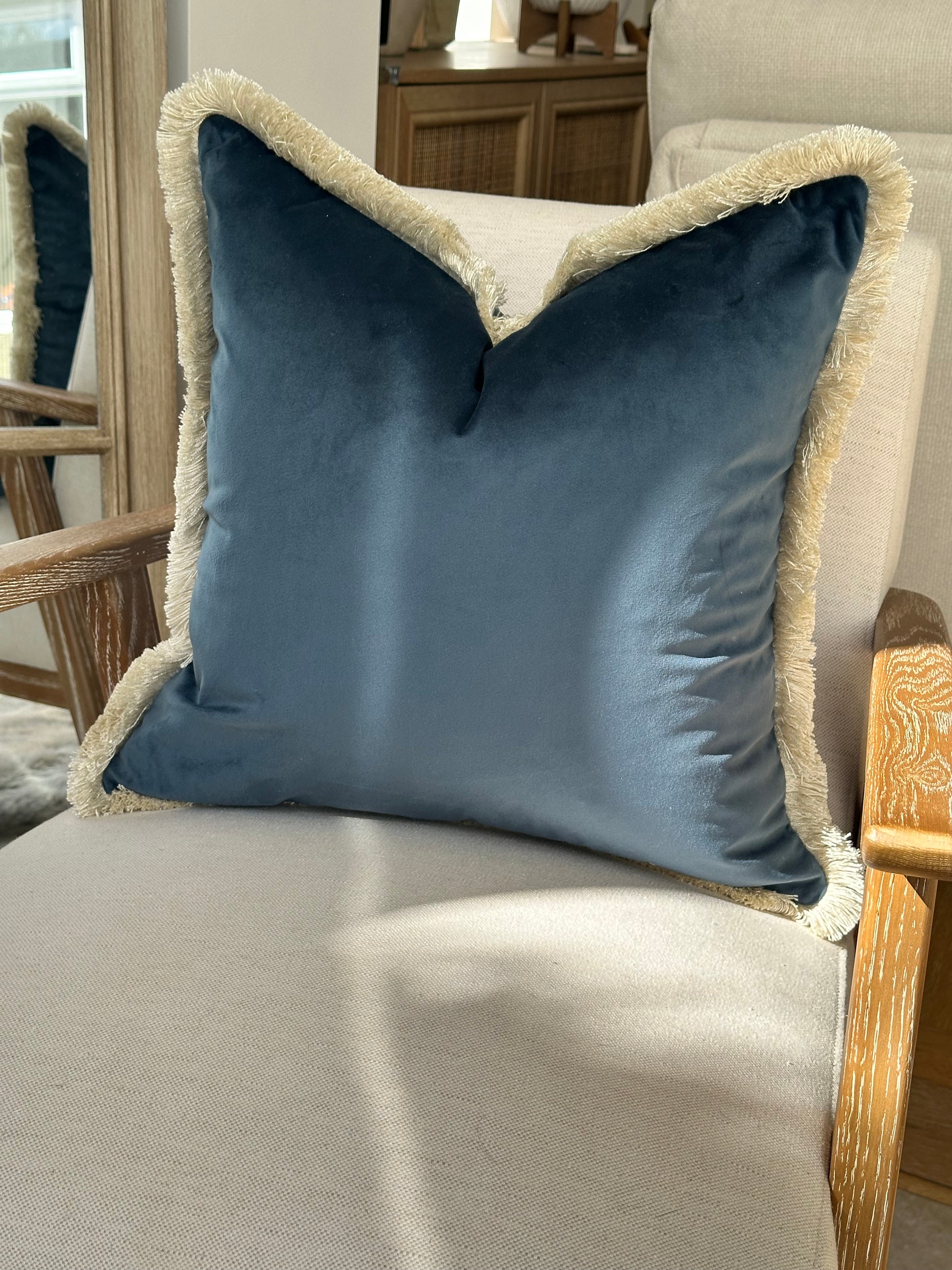 Velvet fringed scatter cushion in petrol blue.