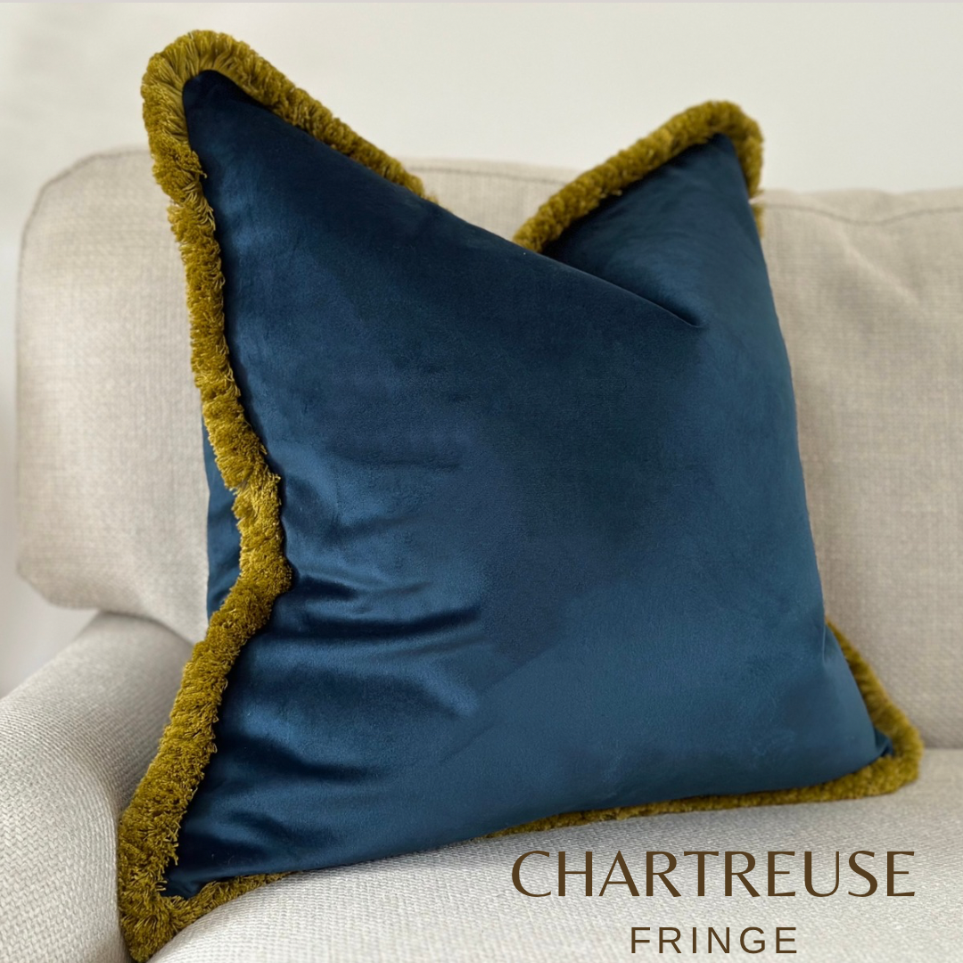Navy blue velvet pillow with chartreuse green yellow fringe trim