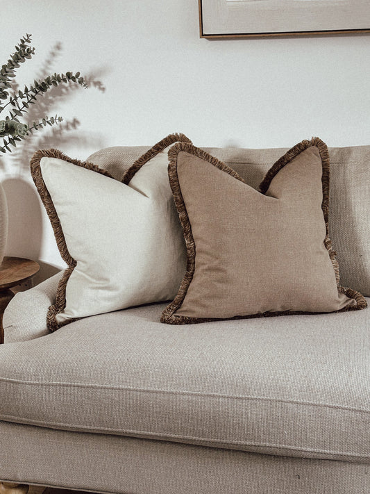Neutral luxury fringed cushions.
