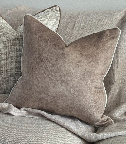 Beige textured look cushion cover with ivory piping.
