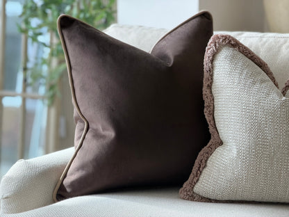 A dark brown velvet pillow cover.