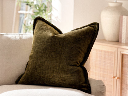 Deep olive green fringed cushion.