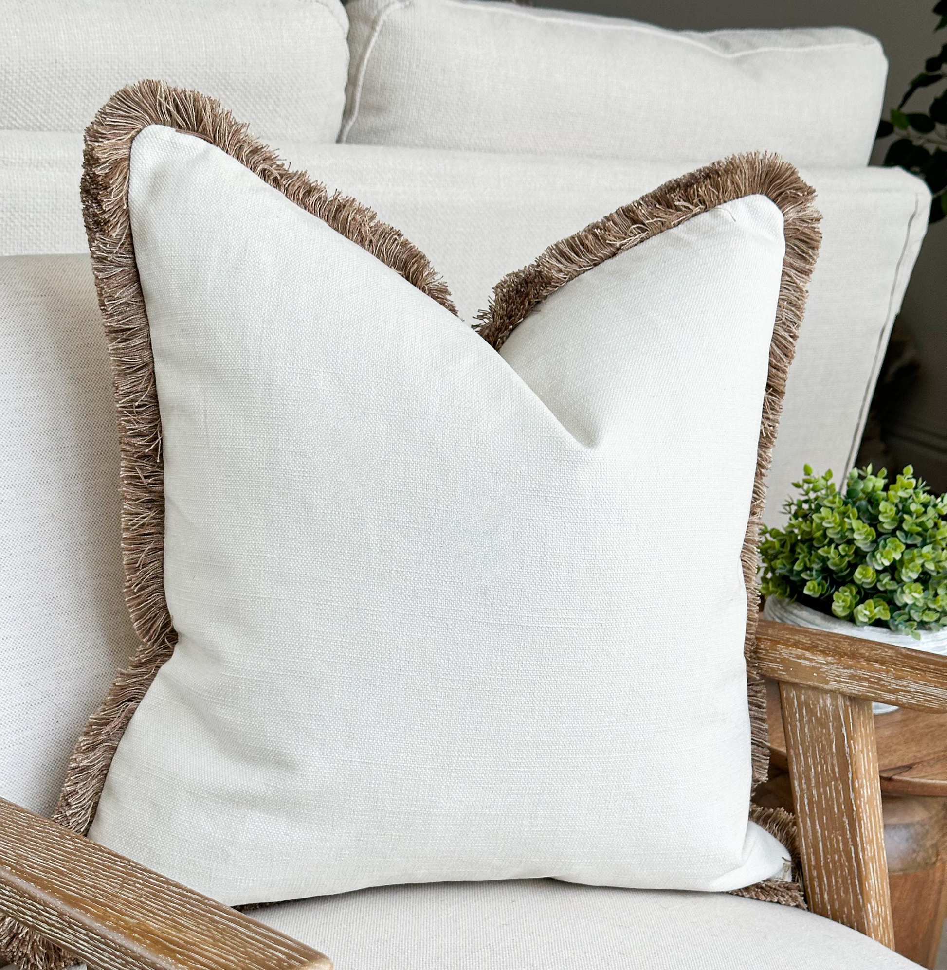 Luxury off white cream fringed cushion.