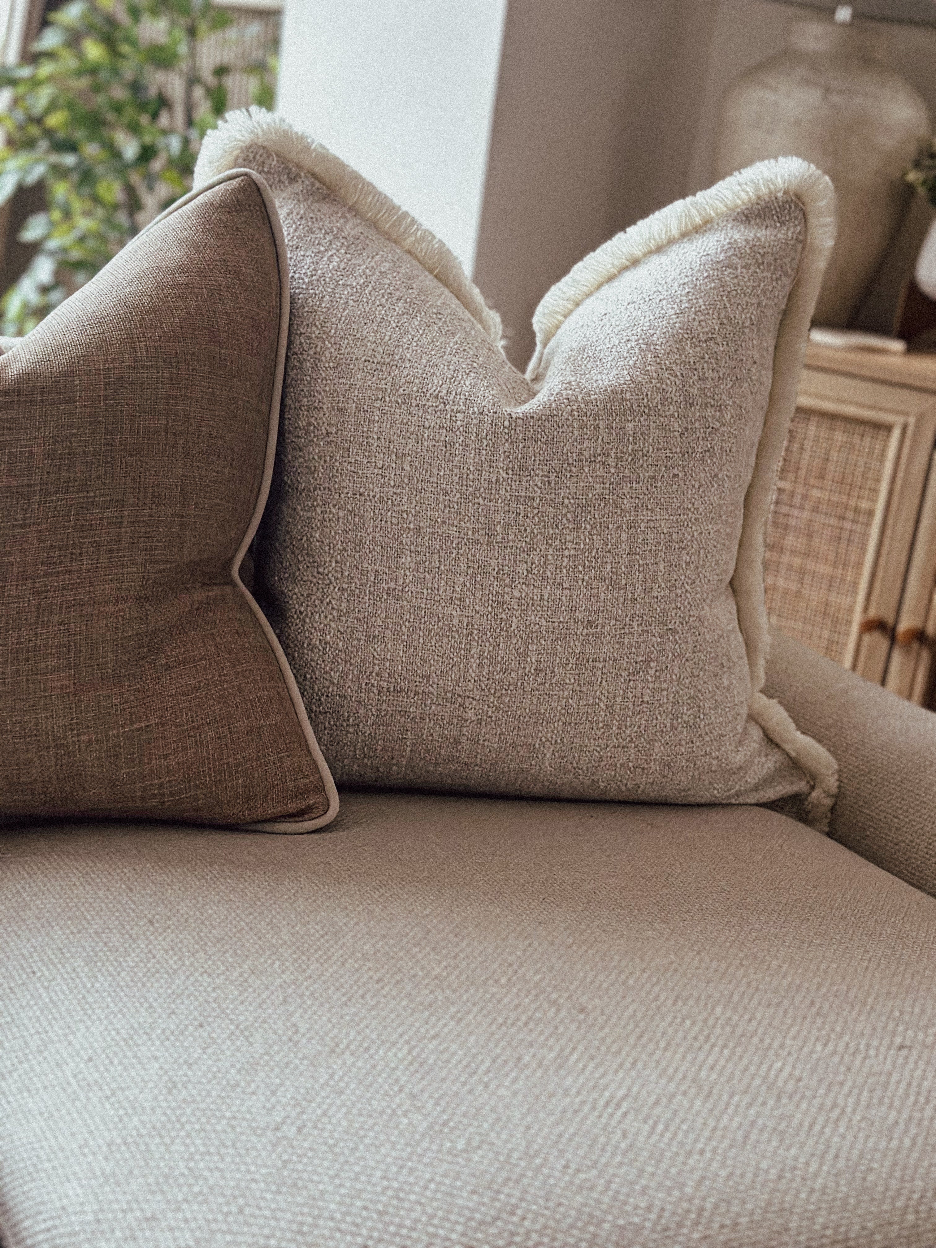 Beige textured scatter cushion with fringed edges — a timeless addition to minimalist or natural home styles.