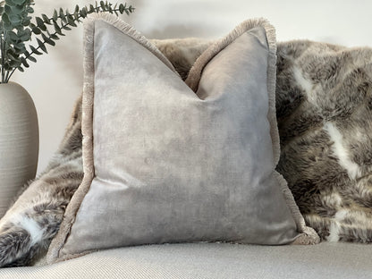Beautiful luxury velvet grey cushion with fringed edge.