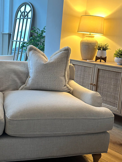 Creamy almond-toned pillow cover with tactile fabric and subtle fringe detail — ideal for calm, earthy interiors.