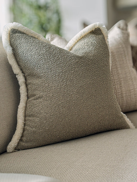 Muted sage green boucle earthy cushion with fringe