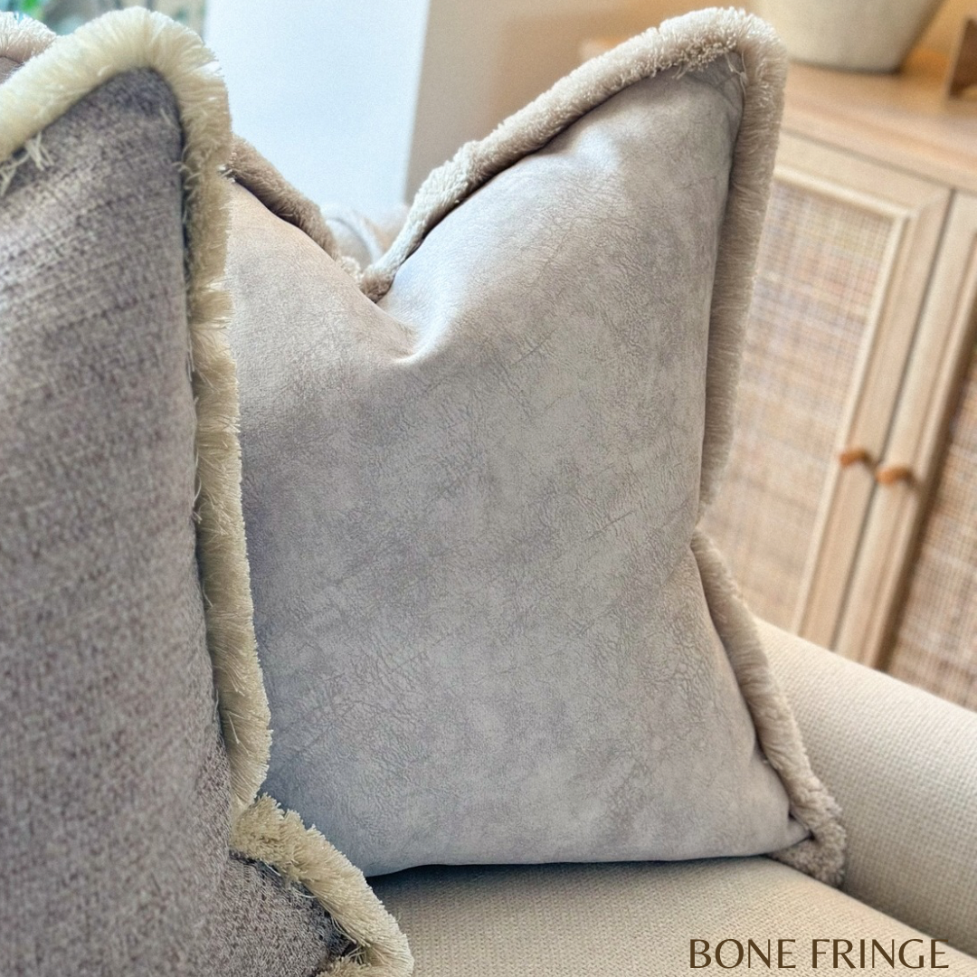 Stone ivory fringed cushion