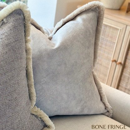 Stone ivory fringed cushion