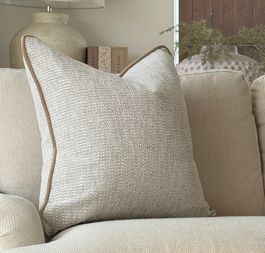 Textured cream and beige cushion with beige piping