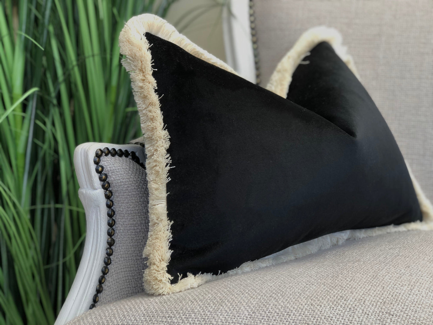 black pillow with fringing