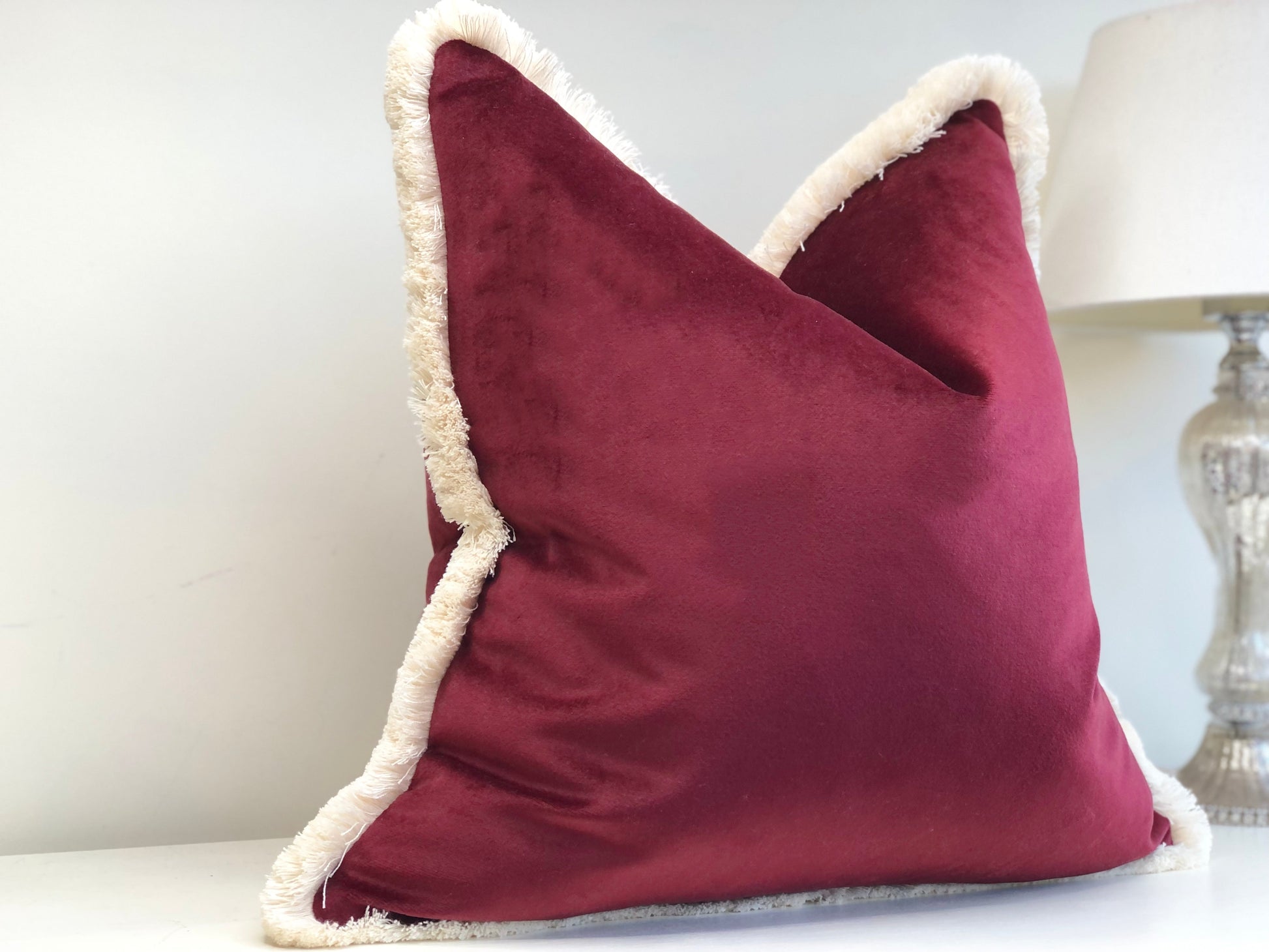 burgundy cushion with fringe