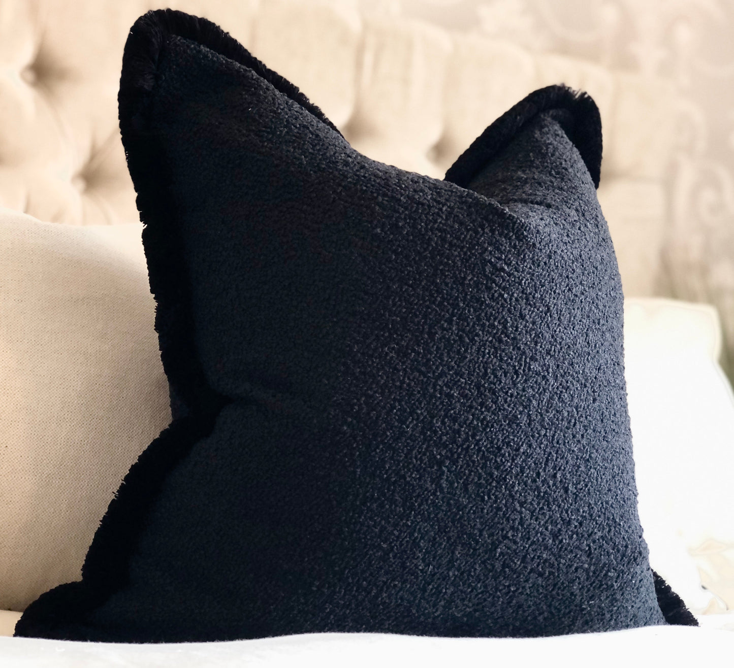 Black boucle fringed cushion